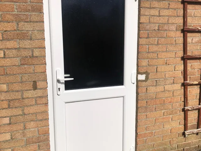 After: A back door beyond saving, rotten and split, renewed with a secure UPVC door.