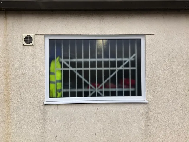 After: Rotten timber window on a commercial unit, replaced with a new double glazed UPVC window.